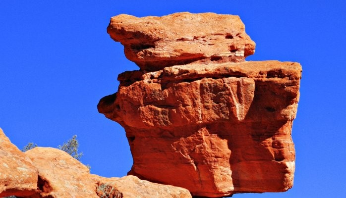 A Picturesque Large Rock Formation Against A Blue Sky